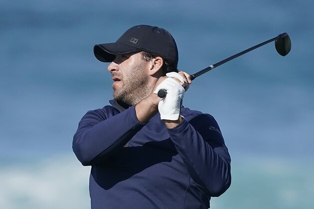 Tony Romo follows his shot from the 13th tee of the Monterey Peninsula County Club Shore Course during the second round of the AT&T Pebble Beach National Pro-Am golf tournament Friday, Feb. 7, 2020, in Pebble Beach, Calif. (AP Photo/Tony Avelar)