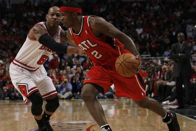 Atlanta Hawks shooting guard Joe Johnson, right, drives on Chicago Bulls shooting guard Keith Bogans during Game 2 of the NBA Eastern Conference semifinal series  Wednesday, May 4, 2011, in Chicago. The Bulls won 86-73. (AP Photo/Charles Rex Arbogast)