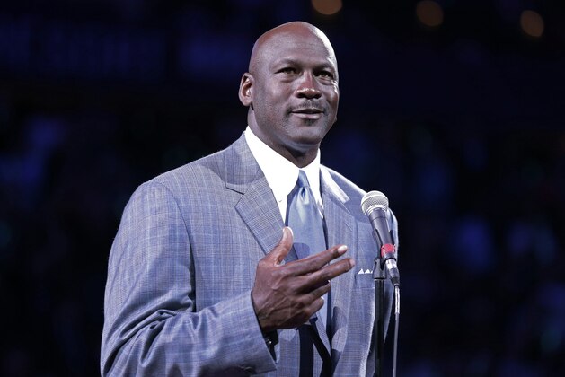Charlotte Bobcats majority owner Michael talks about the team's new name and logo during halftime of an NBA basketball game between the Bobcats and the Utah Jazz in Charlotte, N.C., Saturday, Dec. 21, 2013. The Bobcats will change their name to the Hornets next season. (AP Photo/Chuck Burton)