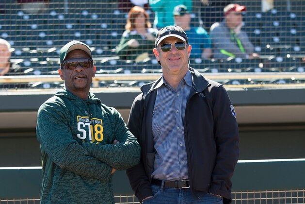 MESA, AZ - FEBRUARY 24: Special Assistant to the President Rickey Henderson and Managing Partner John Fisher of the Oakland Athletics talk on the field prior to the game against the San Diego Padres at Hohokam Stadium on February 24, 2018 in Mesa, Arizona. (Photo by Michael Zagaris/Oakland Athletics/Getty Images)  *** Local Caption *** Rickey Henderson;John Fisher