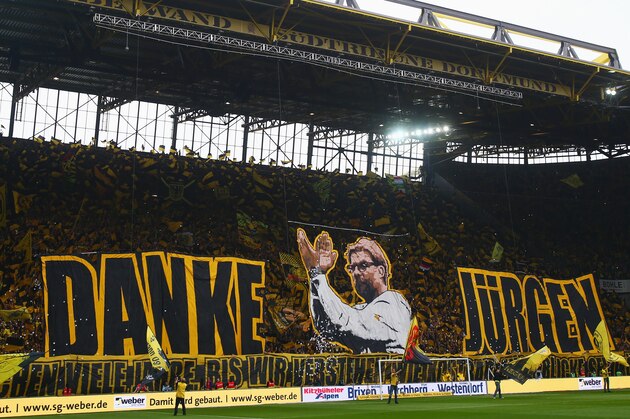 Dortmund's fans celebrate Dortmund's head coach Juergen Klopp prior to German first division Bundesliga football match between Borussia Dortmund and SV Werder Bremen at the Signal Iduna Park in Dortmund, western Germany on May 23, 2015. The match is Klopp's last home league game as Borussia Dortmund coach. AFP PHOTO / PATRIK STOLLARZ

RESTRICTIONS - DFL RULES TO LIMIT THE ONLINE USAGE DURING MATCH TIME TO 15 PICTURES PER MATCH. IMAGE SEQUENCES TO SIMULATE VIDEO IS NOT ALLOWED AT ANY TIME. FOR FURTHER QUERIES PLEASE CONTACT DFL DIRECTLY AT + 49 69 650050.        (Photo credit should read PATRIK STOLLARZ/AFP via Getty Images)