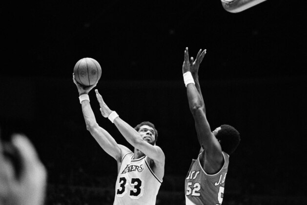 Los Angeles Lakers Kareem Abdul-Jabbar (33) hooks shot over Portland Trail Blazers Jim Brewer (52) during first period of game in Los Angeles, March 13, 1980. Jabbar scored 30 points in the game, giving him over 24,000 career points and pacing the Lakers to a 102-94 win.  (AP Photo/Lennox McLendon)