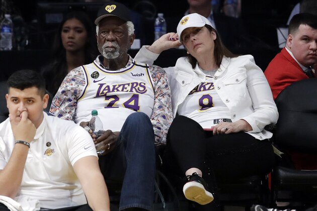 Former Boston Celtic player Bill Russell, left, watches an NBA basketball game between the Los Angeles Lakers and the Boston Celtics Sunday, Feb. 23, 2020, in Los Angeles. (AP Photo/Marcio Jose Sanchez)