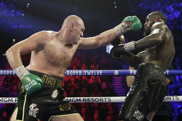 Tyson Fury, left, of England, fights Deontay Wilder during a WBC heavyweight championship boxing match Saturday, Feb. 22, 2020, in Las Vegas. (AP Photo/Isaac Brekken)