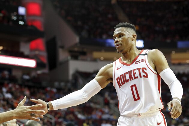 HOUSTON, TEXAS - MARCH 08: Russell Westbrook #0 of the Houston Rockets is greeted by teammates on the bench in the first half against the Orlando Magic at Toyota Center on March 08, 2020 in Houston, Texas.  NOTE TO USER: User expressly acknowledges and agrees that, by downloading and or using this photograph, User is consenting to the terms and conditions of the Getty Images License Agreement. (Photo by Tim Warner/Getty Images)