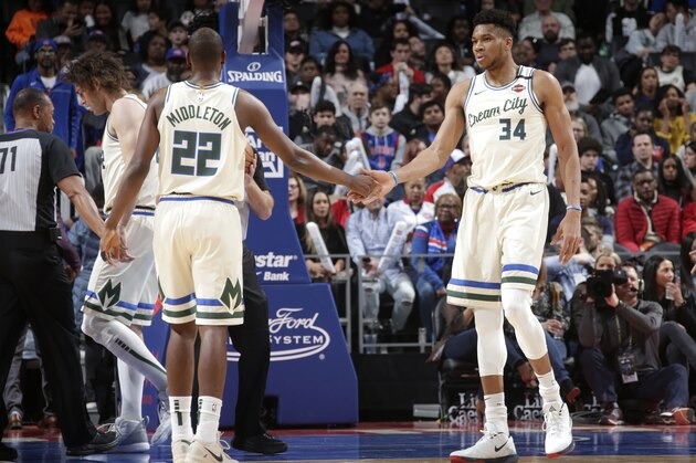 DETROIT, MI - FEBRUARY 20: Khris Middleton #22 of the Milwaukee Bucks high-fives Giannis Antetokounmpo #34 of the Milwaukee Bucks against the Detroit Pistons on February 20, 2020 at Little Caesars Arena in Detroit, Michigan. NOTE TO USER: User expressly acknowledges and agrees that, by downloading and/or using this photograph, User is consenting to the terms and conditions of the Getty Images License Agreement. Mandatory Copyright Notice: Copyright 2020 NBAE (Photo by Brian Sevald/NBAE via Getty Images)