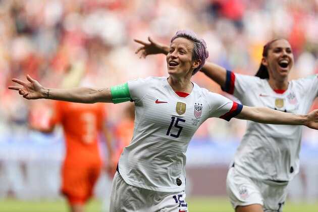 LYON, FRANCE - JULY 07: Megan Rapinoe of the USA celebrates scoring the first goal from the penalty spot with Alex Morgan during the 2019 FIFA Women's World Cup France Final match between The United State of America and The Netherlands at Stade de Lyon on July 07, 2019 in Lyon, France. (Photo by Richard Heathcote/Getty Images) LYON, FRANCE - JULY 07: Megan Rapinoe of the USA celebrates scoring the first goal from the penalty spot with Alex Morgan during the 2019 FIFA Women's World Cup France Final match between The United State of America and The Netherlands at Stade de Lyon on July 07, 2019 in Lyon, France. (Photo by Richard Heathcote/Getty Images)