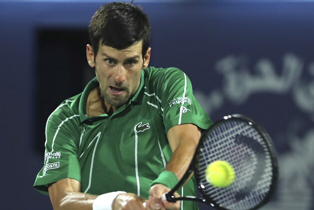 Serbia's Novak Djokovic returns the ball to Stefanos Tsitsipas of Greece during the final match of the Dubai Duty Free Tennis Championship in Dubai, United Arab Emirates, Saturday, Feb. 29, 2020. (AP Photo/Kamran Jebreili)