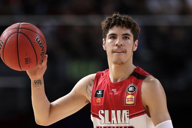 FILE - In this Nov. 17, 2019, file photo, LaMelo Ball of the Illawarra Hawks carries the ball up during their game against the Sydney Kings in the Australian Basketball League in Sydney.  LaMelo Ball's bone bruise on his left foot is expected to keep him out of the Illawarra Hawks lineup for the remainder of the National Basketball League season in Australia. The 18-year-old American, who joined Illawarra as part of the NBL's Next Stars program, is expected to be a first-round pick in this year's NBA draft.(AP Photo/Rick Rycroft, File)