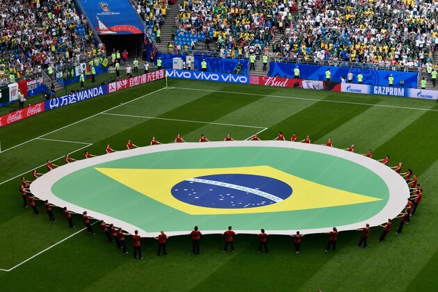 Brazil's national flag is carried during the Russia 2018 World Cup round of 16 football match between Brazil and Mexico at the Samara Arena in Samara on July 2, 2018. (Photo by SAEED KHAN / AFP) / RESTRICTED TO EDITORIAL USE - NO MOBILE PUSH ALERTS/DOWNLOADS (Photo by SAEED KHAN/AFP via Getty Images)