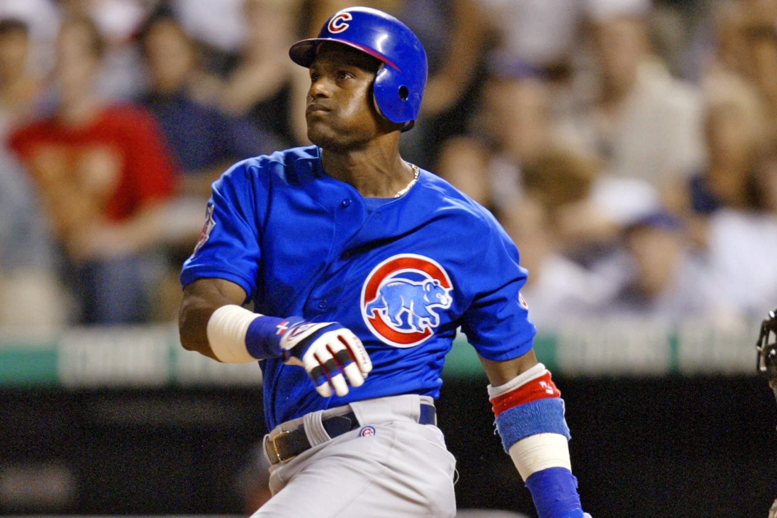 FILE - In this Aug. 4, 2004, file photo, Chicago Cubs' Sammy Sosa hits a three-run home run off Colorado Rockies relief pitcher Scott Dohmann during the seventh inning of a baseball game at Coors Field in Denver. In a Wednesday, Jan. 23, 2013, interview on the website Ustream.com, Sosa said that he thinks he and fellow steroid-tainted star Mark McGwire belong in the Hall of Fame, that the Cubs should retire his number, and he left open the possibility of running for president of the Dominican Republic. (AP Photo/Jack Dempsey, File)