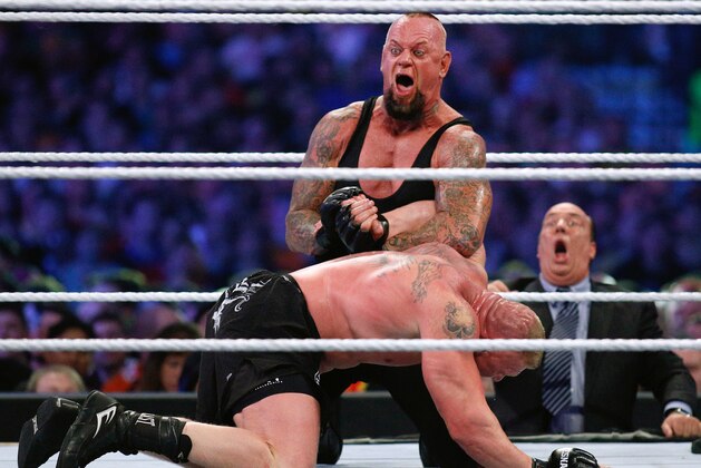 IMAGE DISTRIBUTED FOR WWE - The Undertaker, top, and Brock Lesnar wrestle during Wrestlemania XXX at the Mercedes-Benz Super Dome in New Orleans on Sunday, April 6, 2014. (Jonathan Bachman/AP Images for WWE)