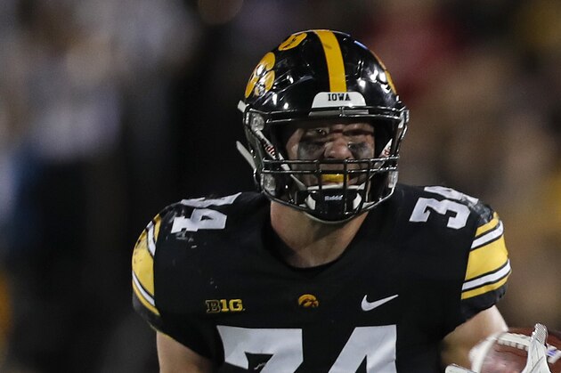 Wisconsin fullback Alec Ingold, right, makes a catch as Iowa linebacker Dillon Doyle, left, trails behind during the first half of an NCAA college football game, Saturday, Sept. 22, 2018, in Iowa City. (AP Photo/Matthew Putney)