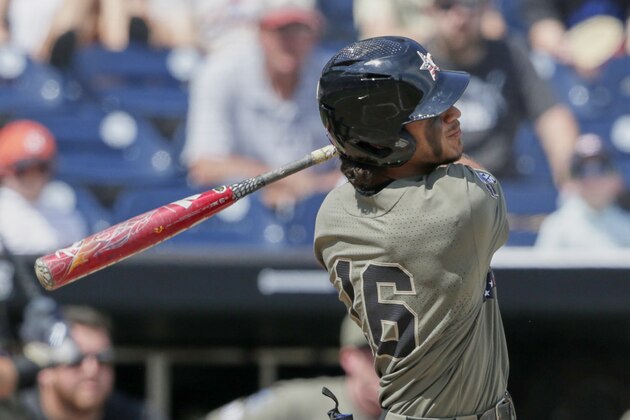Vanderbilt's Austin Martin follows through on his two-run home run against Louisville in the seventh inning of an NCAA College World Series baseball game in Omaha, Neb., Sunday, June 16, 2019. (AP Photo/Nati Harnik)