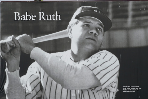 John Cook of Ballston Spa, N.Y., walks atop a billboard featuring baseball legend Babe Ruth after he and co-workers installed it in Half Moon, N.Y., on Wednesday, April 11, 2012. (AP Photo/Mike Groll)