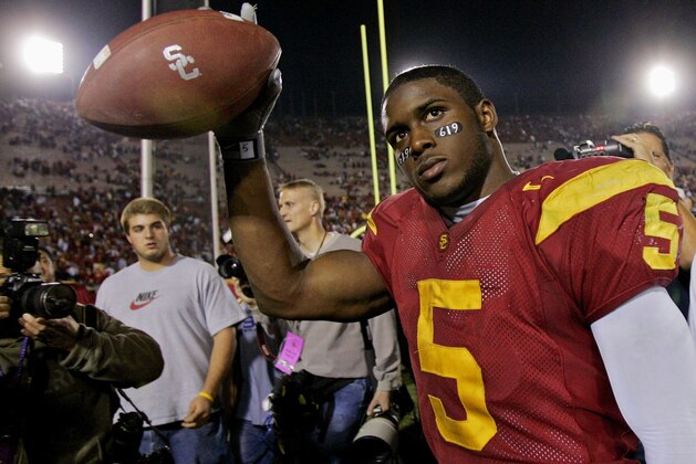 Southern California tail back Reggie Bush walks off the field holding the game ball after the Trojans defeated Fresno State, 50-42, Saturday, Nov. 19, 2005, at the Los Angeles Coliseum. Bush rushed for 294-yards and scored two touchdowns. (AP Photo/Kevork Djansezian)