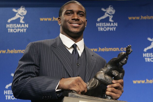 FILE- In this Dec. 10, 2005, file photo, Heisman Trophy winner Reggie Bush of the University of Southern California smiles while posing for photos after a news conference in New York.  Bush said Tuesday, Tuesday, Sept. 14, 2010, that he is forfeiting his Heisman Trophy. (AP Photo/Frank Franklin II, File)