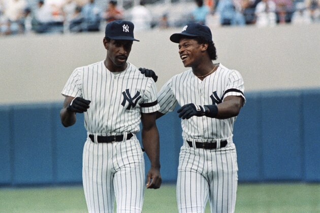 New York Yankees Rickey Henderson, right, welcomes Claudell Washington who was obtained from the Atlanta Braves with Paul Zuvella for Ken Griffey, Monday, June 30, 1986, New York. Washington started on in left field against the Detroit Tigers at Yankee Stadium. (AP Photo/Susan Ragan)