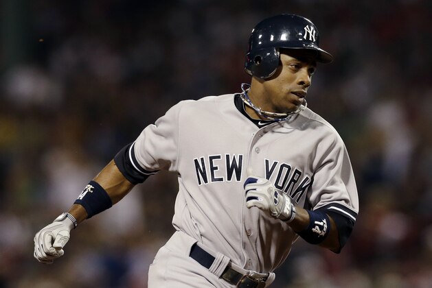 New York Yankees' Curtis Granderson rounds third base after his solo homer during the fourth inning of a baseball game against the Boston Red Sox at Fenway Park in Boston Wednesday, Sept. 12, 2012. (AP Photo/Elise Amendola)
