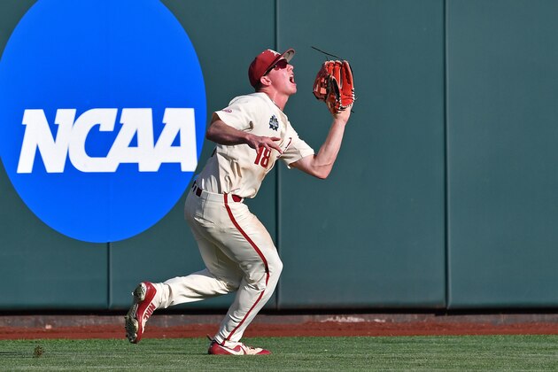 Omaha, NE - JUNE 27:  Outfielder Heston Kjerstad #18 of the Arkansas Razorbacks runs in to make a catch in the second inning against the Oregon State Beavers during game two of the College World Series Championship Series on June 27, 2018 at TD Ameritrade Park in Omaha, Nebraska.  (Photo by Peter Aiken/Getty Images)
