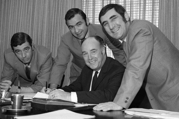 NBA commissioner Walter Kennedy, seated, signs the expansion draft designed to stock new Buffalo, Cleveland and Portland teams with players from the NBA's existing 14 teams, May 11, 1970. With Kennedy, from left: Harry Glickman, vice president of the Portland Trail Blazers; Carl Scheer, president of the Buffalo Braves, and Nick Mileti. Signing took place at NBA headquarters in New York. (AP Photo/Jacob Harris)