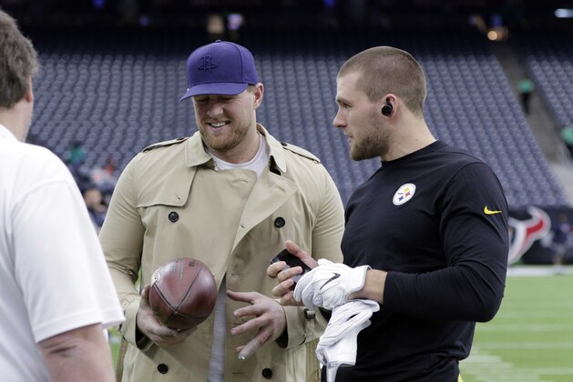 Pittsburgh Steelers outside linebacker T.J. Watt, right, talks with his brother, Houston Texans defensive end J.J. Watt, center, before an NFL football game Monday, Dec. 25, 2017, in Houston. (AP Photo/Michael Wyke)