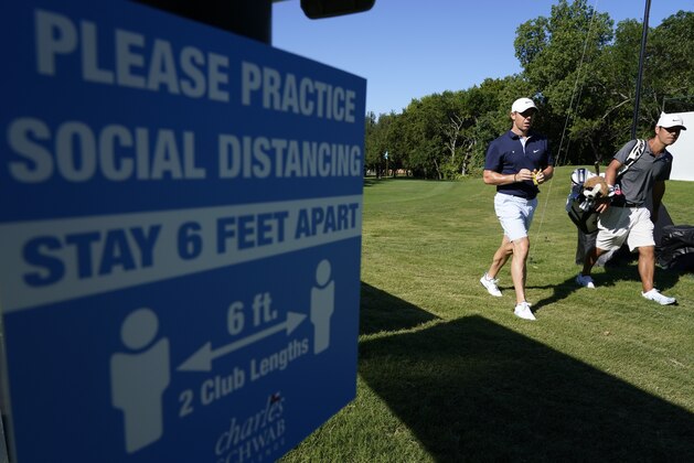 Rory McIlroy, of Northern Ireland, and his caddie walk off the seventh green during practice for the Charles Schwab Challenge golf tournament at the Colonial Country Club in Fort Worth, Texas, Wednesday, June 10, 2020. (AP Photo/David J. Phillip)