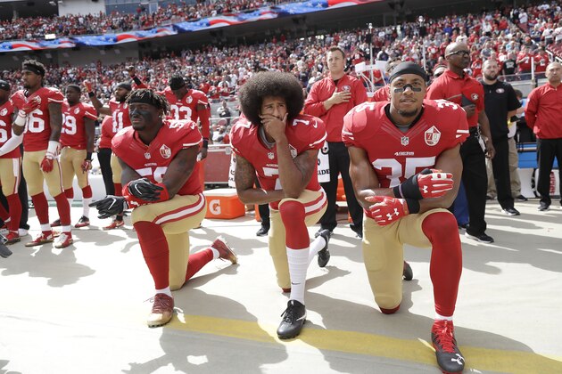 San Francisco 49ers outside linebacker Eli Harold, left, quarterback Colin Kaepernick, center, and safety Eric Reid kneel during the national anthem before an NFL football game against the Dallas Cowboys in Santa Clara, Calif., Sunday, Oct. 2, 2016. (AP Photo/Marcio Jose Sanchez)