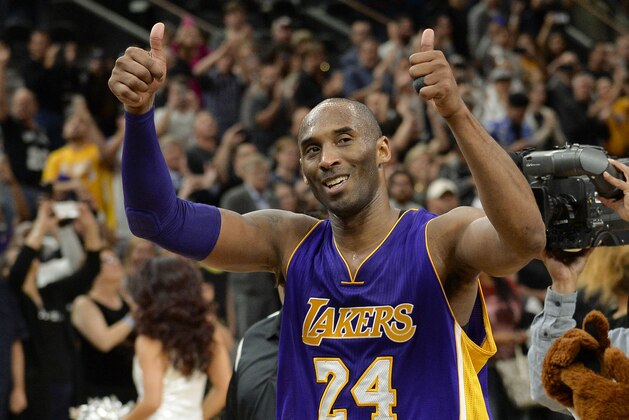 Los Angeles Lakers guard Kobe Bryant gestures to fans as he walks off of the court after an NBA basketball game against the San Antonio Spurs, Saturday, Feb. 6, 2016, in San Antonio. San Antonio won 106-102. (AP Photo/Darren Abate)