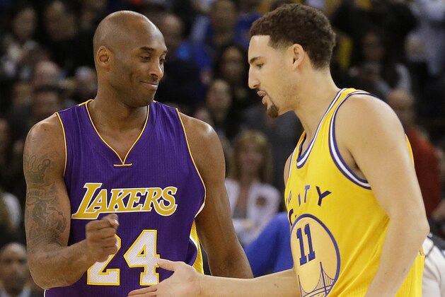 Los Angeles Lakers guard Kobe Bryant (24) greets Golden State Warriors guard Klay Thompson (11) before an NBA basketball game in Oakland, Calif., Tuesday, Nov. 24, 2015. (AP Photo/Jeff Chiu)
