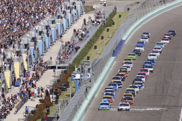 Denny Hamlin (11) leads the field to start a NASCAR Cup Series auto race on Sunday, Nov. 17, 2019, at Homestead-Miami Speedway in Homestead, Fla. (AP Photo/Jim Topper)