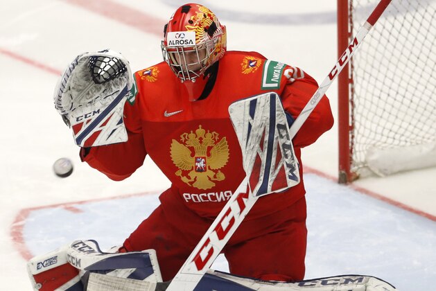 Russia's goaltender Yaroslav Askarov makes a save during the U20 Ice Hockey Worlds semifinal match between Sweden and Russia in Ostrava, Czech Republic, Saturday, Jan. 4, 2020. (AP Photo/Petr David Josek)