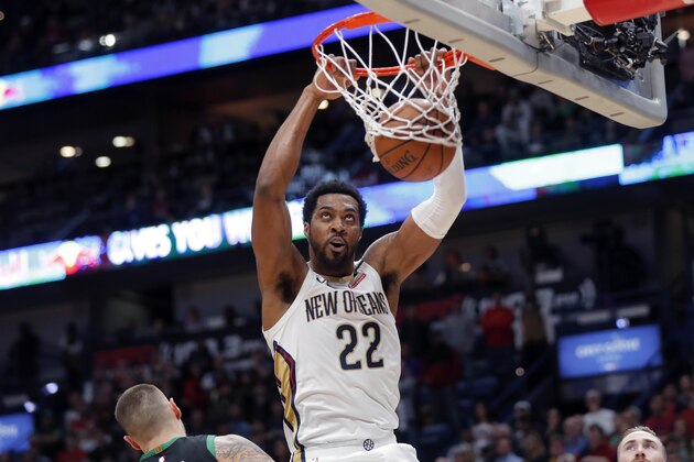 New Orleans Pelicans center Derrick Favors (22) slam-dunks over Boston Celtics center Daniel Theis in the first half of an NBA basketball game in New Orleans, Sunday, Jan. 26, 2020. (AP Photo/Gerald Herbert) New Orleans Pelicans center Derrick Favors (22) slam-dunks over Boston Celtics center Daniel Theis in the first half of an NBA basketball game in New Orleans, Sunday, Jan. 26, 2020. (AP Photo/Gerald Herbert)