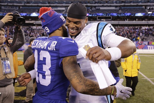 Carolina Panthers' Cam Newton, right, hugs New York Giants' Odell Beckham (13) after an NFL football game Sunday, Dec. 20, 2015, in East Rutherford, N.J. The Panthers won 38-35. (AP Photo/Peter Morgan)