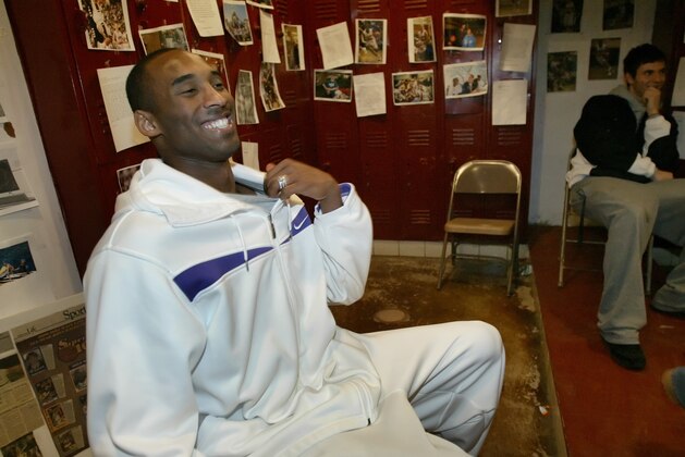 Kobe Bryant laughs while talking to the boy's varsity basketball team inside the team's locker room while visiting Lower Merion High School in Ardmore Pa., on Friday, Mar. 9, 2007. Bryant is still the most popular guy around at Lower Merion High, in the Philadelphia suburbs, and his trip back on Friday before the Lakers played the 76ers sent the student population into a frenzy not unlike when he led the 1996 basketball team to a state championship. (AP Photo/ Joseph Kaczmarek)
