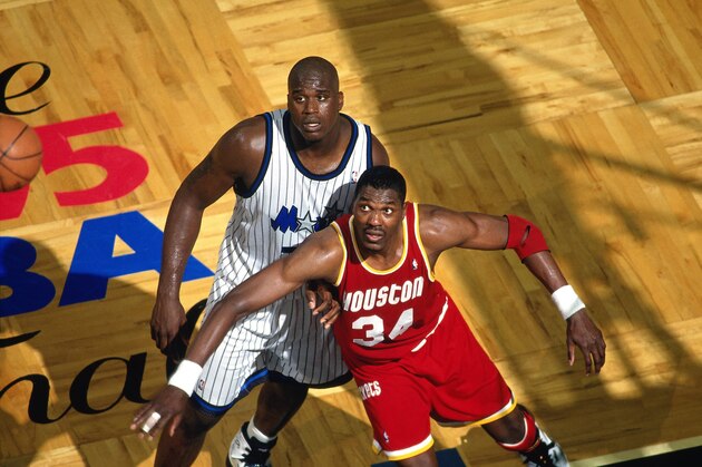 ORLANDO, FL - JUNE 7:  Hakeem Olajuwon #34 of the Houston Rockets boxes out againt Shaquille O'Neal #34 of the Orlando Magic during Game One of the 1995 NBA Finals played on June 7, 1995 at the Orlando Arena in Orlando, Florida. Houston won the game 120-118 and the swept the series 4-0 to win the 1995 NBA Championship.  NOTE TO USER: User expressly acknowledges and agrees that, by downloading and or using this photograph, User is consenting to the terms and conditions of the Getty Images License Agreement. Mandatory Copyright Notice: Copyright 1995 NBAE (Photo by Fernando Medina/NBAE via Getty Images)