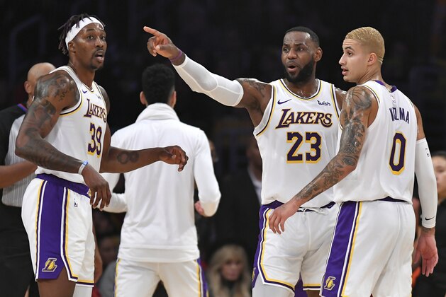 LOS ANGELES, CA - JANUARY 01: Dwight Howard #39, Lakers LeBron James and Kyle Kuzma #0 of the Los Angeles Lakers play the Phoenix Suns at Staples Center on January 1, 2020 in Los Angeles, California. NOTE TO USER: User expressly acknowledges and agrees that, by downloading and/or using this photograph, user is consenting to the terms and conditions of the Getty Images License Agreement. (Photo by John McCoy/Getty Images)