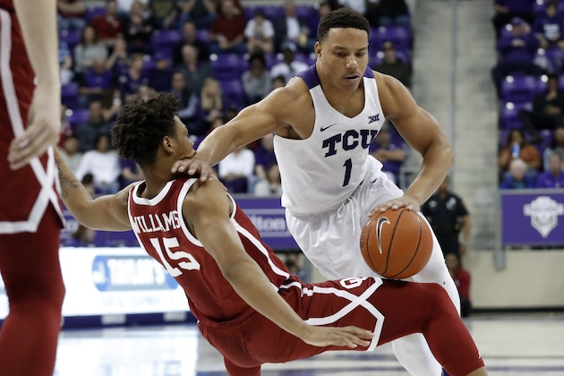 Oklahoma guard Alondes Williams (15) is knocked backwards defending against a drive to the basket by TCU guard Desmond Bane (1) in the second half of an NCAA college basketball game in Fort Worth, Texas, Saturday, March 7, 2020. (AP Photo/Tony Gutierrez)