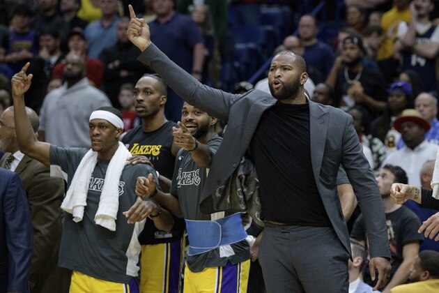 Los Angeles Lakers player DeMarcus Cousins, right, who previously played with the New Orleans Pelicans cheers for his team during an NBA basketball game in New Orleans, Wednesday, Nov. 27, 2019. (AP Photo/Matthew Hinton)