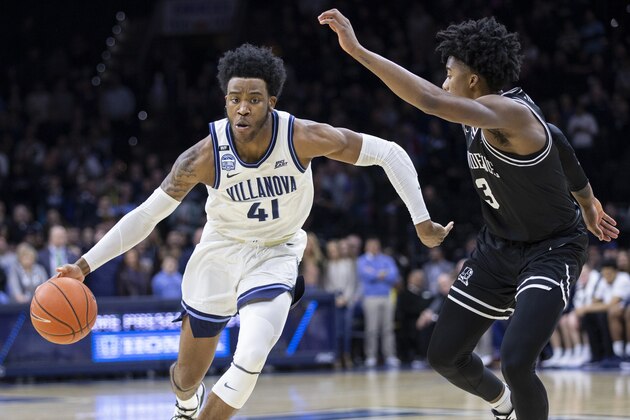 Villanova forward Saddiq Bey (41) moves around Providence guard David Duke (3) during the first half of an NCAA college basketball game, Saturday, Feb. 29, 2020, in Philadelphia, Pa. (AP Photo/Laurence Kesterson)
