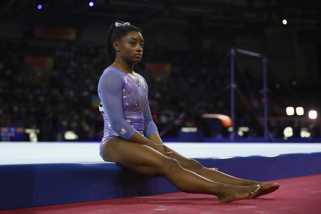 FILE - In this Oct. 13, 2019, file photo, gold medalist Simone Biles of the United States waits to perform on the floor in the women's apparatus finals at the Gymnastics World Championships in Stuttgart, Germany. Biles is pressing on to the 2021 Olympics. While she's confident her body will be fine next summer, she is concerned about the mental toll of another year of training. (AP Photo/Matthias Schrader, File)