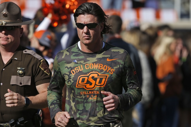 Oklahoma State head coach Mike Gundy runs onto the field before an NCAA college football game against Kansas in Stillwater, Okla., Saturday, Nov. 16, 2019. (AP Photo/Sue Ogrocki)