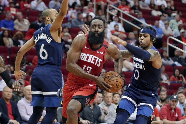 Houston Rockets guard James Harden (13) drives to the basket between Minnesota Timberwolves guard Jordans McLaughlin (6) and D'Angelo Russell (0) during the second half of an NBA basketball game Tuesday, March 10, 2020, in Houston. (AP Photo/Michael Wyke)