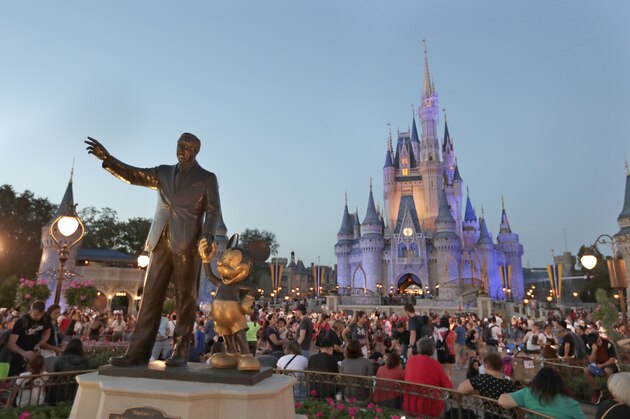 In this Wednesday, Jan. 15, 2020 photo, a statue of Walt Disney and Mickey Mouse is seen in front of the Cinderella Castle at the Magic Kingdom theme park at Walt Disney World in Lake Buena Vista, Fla. (AP Photo/John Raoux)