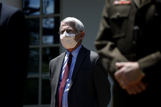 Director of the National Institute of Allergy and Infectious Diseases Dr. Anthony Fauci listens as President Donald Trump speaks about the coronavirus in the Rose Garden of the White House, Friday, May 15, 2020, in Washington. (AP Photo/Alex Brandon)