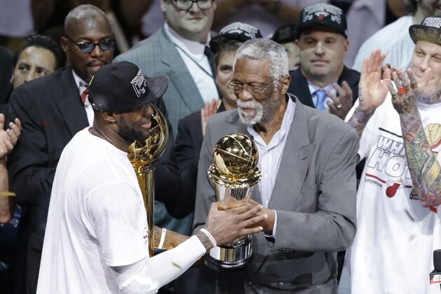 Former NBA player Bill Russell, right, presents Miami Heat's LeBron James with the Bill Russell MVP Award after the Heat won Game 7 of the NBA basketball championships, Friday, June 21, 2013, in Miami. The Miami Heat defeated the San Antonio Spurs 95-88 to win their second straight NBA championship. (AP Photo/Wilfredo Lee)