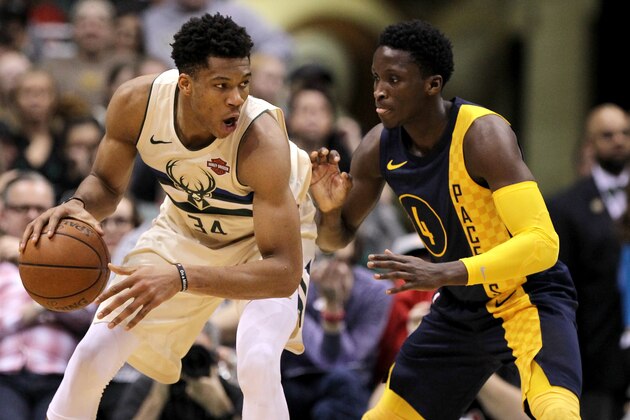 MILWAUKEE, WI - MARCH 02:  Giannis Antetokounmpo #34 of the Milwaukee Bucks dribbles the ball while being guarded by Victor Oladipo #4 of the Indiana Pacers in the fourth quarter at the Bradley Center on March 2, 2018 in Milwaukee, Wisconsin. NOTE TO USER: User expressly acknowledges and agrees that, by downloading and or using this photograph, User is consenting to the terms and conditions of the Getty Images License Agreement. (Photo by Dylan Buell/Getty Images)
