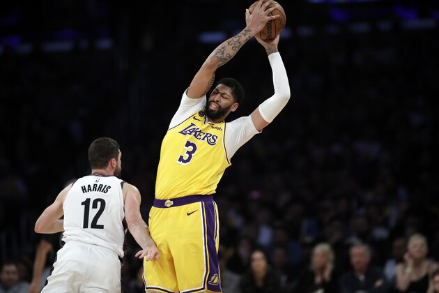 Los Angeles Lakers' Anthony Davis (3) is defended by Brooklyn Nets' Joe Harris (12) during the second half of an NBA basketball game Tuesday, March 10, 2020, in Los Angeles. (AP Photo/Marcio Jose Sanchez) Los Angeles Lakers' Anthony Davis (3) is defended by Brooklyn Nets' Joe Harris (12) during the second half of an NBA basketball game Tuesday, March 10, 2020, in Los Angeles. (AP Photo/Marcio Jose Sanchez)