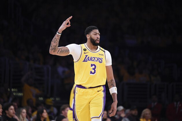 Los Angeles Lakers forward Anthony Davis reacts after a shot made by Kentavious Caldwell-Pope during the first half of an NBA basketball game against the Portland Trail Blazers in Los Angeles, Friday, Jan. 31, 2020. (AP Photo/Kelvin Kuo)