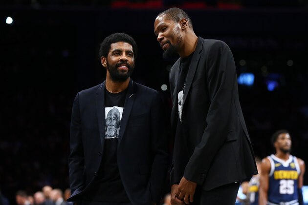 NEW YORK, NEW YORK - DECEMBER 08: Kevin Durant #7 and Kyrie Irving #11 of the Brooklyn Nets share a laugh during the game against the Denver Nuggets at Barclays Center on December 08, 2019 in New York City. Brooklyn Nets defeated the Denver Nuggets 105-102. NOTE TO USER: User expressly acknowledges and agrees that, by downloading and or using this photograph, User is consenting to the terms and conditions of the Getty Images License Agreement.  (Photo by Mike Stobe/Getty Images)
